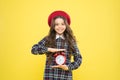 Good morning. Small child smiling in morning on yellow background. Happy little girl holding alarm clock early in the Royalty Free Stock Photo