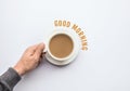 Good morning text with male hand holding cup of coffee.business Royalty Free Stock Photo