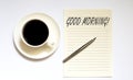 GOOD MORNING - white paper with pen and coffee on wooden background Royalty Free Stock Photo