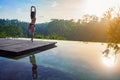 Good morning with woman yoga meditating on sunrise background.