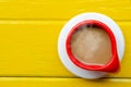 Good morning world.Red cup of coffee on yellow background,top vi Royalty Free Stock Photo