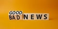 Good news and Bad news symbol. Turned wooden cubes with words Bad news and Good news. Beautiful orange background. Business Royalty Free Stock Photo