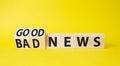 Good news and Bad news symbol. Turned wooden cubes with words Bad news and Good news. Beautiful yellow background. Business Royalty Free Stock Photo