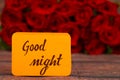 Good Night text with Red roses in a bunch as a background. Royalty Free Stock Photo