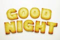 Good night word from alphabet biscuits on white background