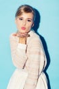 Good old-fashioned flirting. A sweet young woman in retro attire blowing a kiss to the camera - portrait. Royalty Free Stock Photo