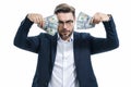 Good payment. Handsome business man holding money isolated over grey studio. Money in dollar banknotes. Pile of cash Royalty Free Stock Photo