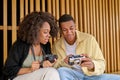 Man showing camera to woman sitting outdoors