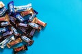 Twix, Milky Way, Snickers, Bounty, Mars popular mini candy chocolate bars on blue background with copy space