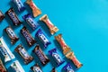 Twix, Milky Way, Snickers, Bounty, Mars popular mini candy chocolate bars on blue background