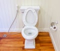 Good preparing of clean, white and sterile toilet in a white wall bathroom.