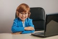 Good pupil is holding his arms on the desk Royalty Free Stock Photo