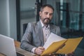 Satisfied business man looking at document Royalty Free Stock Photo