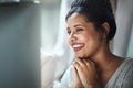 Good reviews make her day. Shot of a happy young businesswoman looking at her computer screen while sitting in the Royalty Free Stock Photo