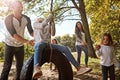 Good, simple swinging fun. a happy father pushing his daughter on a tyre swing. Royalty Free Stock Photo