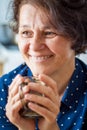 A good stylish middle-aged woman with a cup of coffee. Smiling w