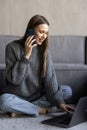 Good talk with boyfriend. Attractive woman talking on mobile phone and smiling while sitting on the carpet at home Royalty Free Stock Photo