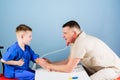 Good team. happy child with father with stethoscope. nurse laboratory assistant. family doctor. father and son in Royalty Free Stock Photo