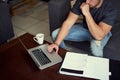 Good things come to those who work. Shot of an unidentifiable young man using his laptop to work from home.