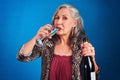 Good times start with a glass of champagne. Portrait of a funky and cheerful senior woman drinking champagne in studio