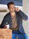 So good to hear from you again. a young man sitting in a cafe and talking on a cellphone. Royalty Free Stock Photo