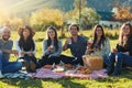 Good vibes and great times. Portrait of a group of friends having a picnic together outdoors. Royalty Free Stock Photo