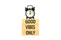 Good vibes only symbol. Concept word Good vibes only on beautiful wooden block. Black alarm clock. Beautiful white table white Royalty Free Stock Photo