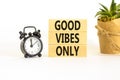 Good vibes only symbol. Concept word Good vibes only on beautiful wooden block. Black alarm clock. Beautiful white table white Royalty Free Stock Photo