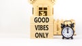 Good vibes only symbol. Concept word Good vibes only on beautiful wooden block. Black alarm clock. Beautiful white table white Royalty Free Stock Photo