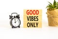 Good vibes only symbol. Concept word Good vibes only on beautiful wooden block. Black alarm clock. Beautiful white table white Royalty Free Stock Photo