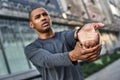 Good warm-up. Close up portrait of african sportsman doing stretching exercise for warming up.