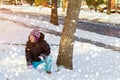 Good winter weather happy kid is playing in snow in snowflakes Royalty Free Stock Photo