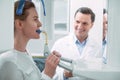 Exuberant dentist watching his patient