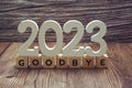 Goodbye 2023 alphabet letter on wooden background