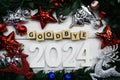 Goodbye 2024 alphabet letters and christmas decoration on wooden background