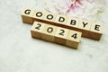 Goodbye 2024 alphabet letters on marble background