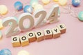 Goodbye 2024 alphabet letters with space copy on pink background