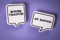 Goodbye and Good Luck in French. Text on speech bubbles. Purple background Royalty Free Stock Photo