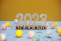 Goodbye 2023 letters with LED cotton balls decoration on blue background