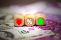 The dice show a red green arrow and the percentage of the Euro and the Dolla Royalty Free Stock Photo