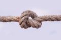 Tied knot on a white rope isolated on white background. Macro photo Royalty Free Stock Photo