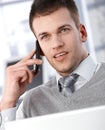 Goodlooking businessman talking on mobile phone