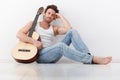 Goodlooking man with guitar smiling