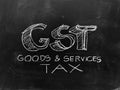 Goods & Services Tax - GST - Handwritten on Blackboard - Stock I