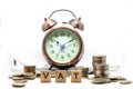 Goods and Services Tax word on Alarm clock and stacks coins on white table, Success in business