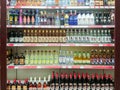 Goods on the shelf of a grocery store. A variety of alcoholic beverages.