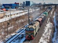 Goods train carries cargo on railway track.