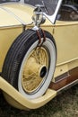 GOODWOOD, WEST SUSSEX/UK - SEPTEMBER 14 : Spare wheel on a vintage yellow Rolls Royce car at Goodwood on SEPTEMBER 14, 2012