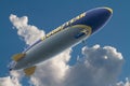 Goodyear Blimp Floating in Partly Cloudy Sky