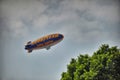 Goodyear blimp flying in cloudy sky